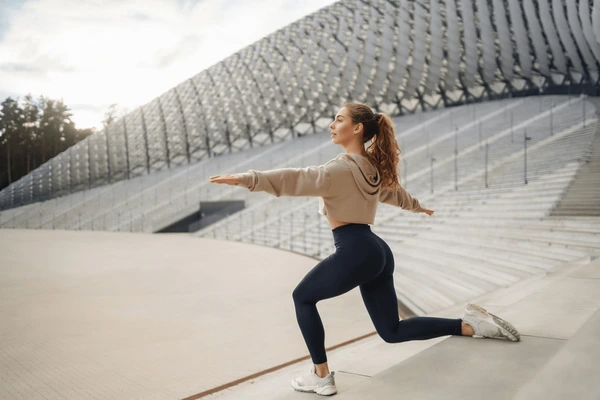 An athlete performing guided stretching exercises under the supervision of Dr. Gracewin, a leading physiotherapist in Nagercoil, focusing on flexibility and injury prevention