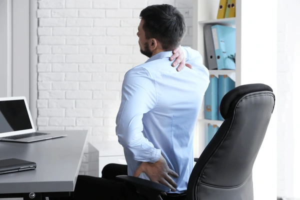 A physiotherapist guiding a patient through posture correction exercises in a modern clinic.
